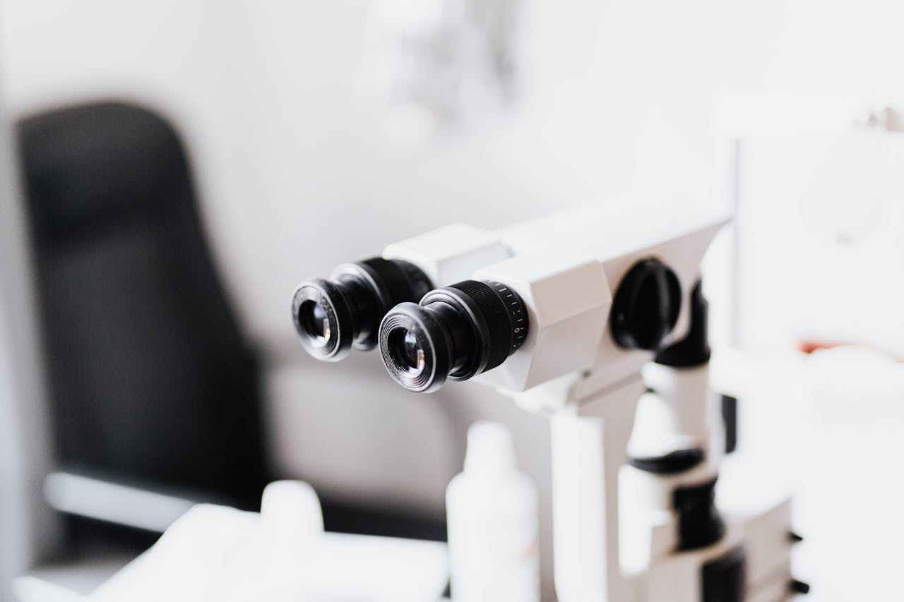Close-up of a professional microscope in a laboratory environment with selective focus.